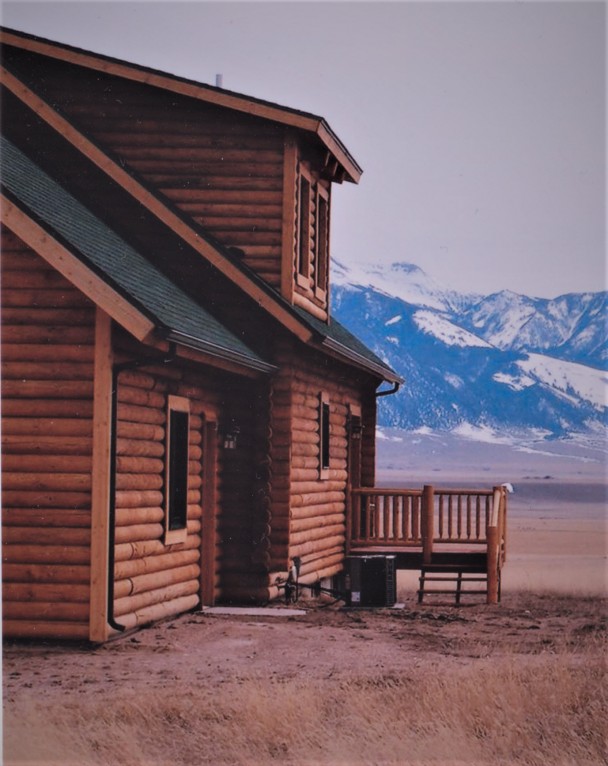 Log Cabin House with Rocky Mountains