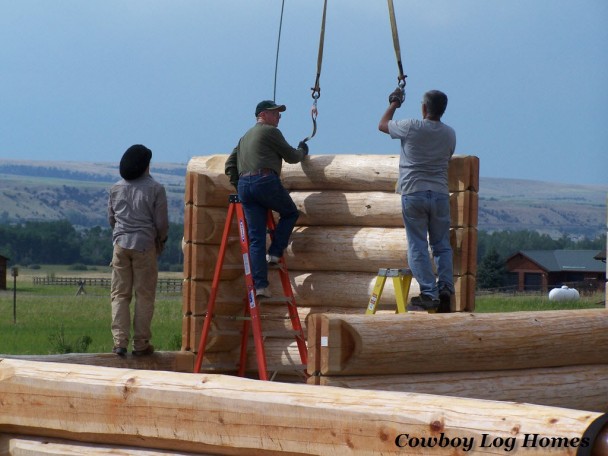 handcrafted log home builder mike lemmon on ladder